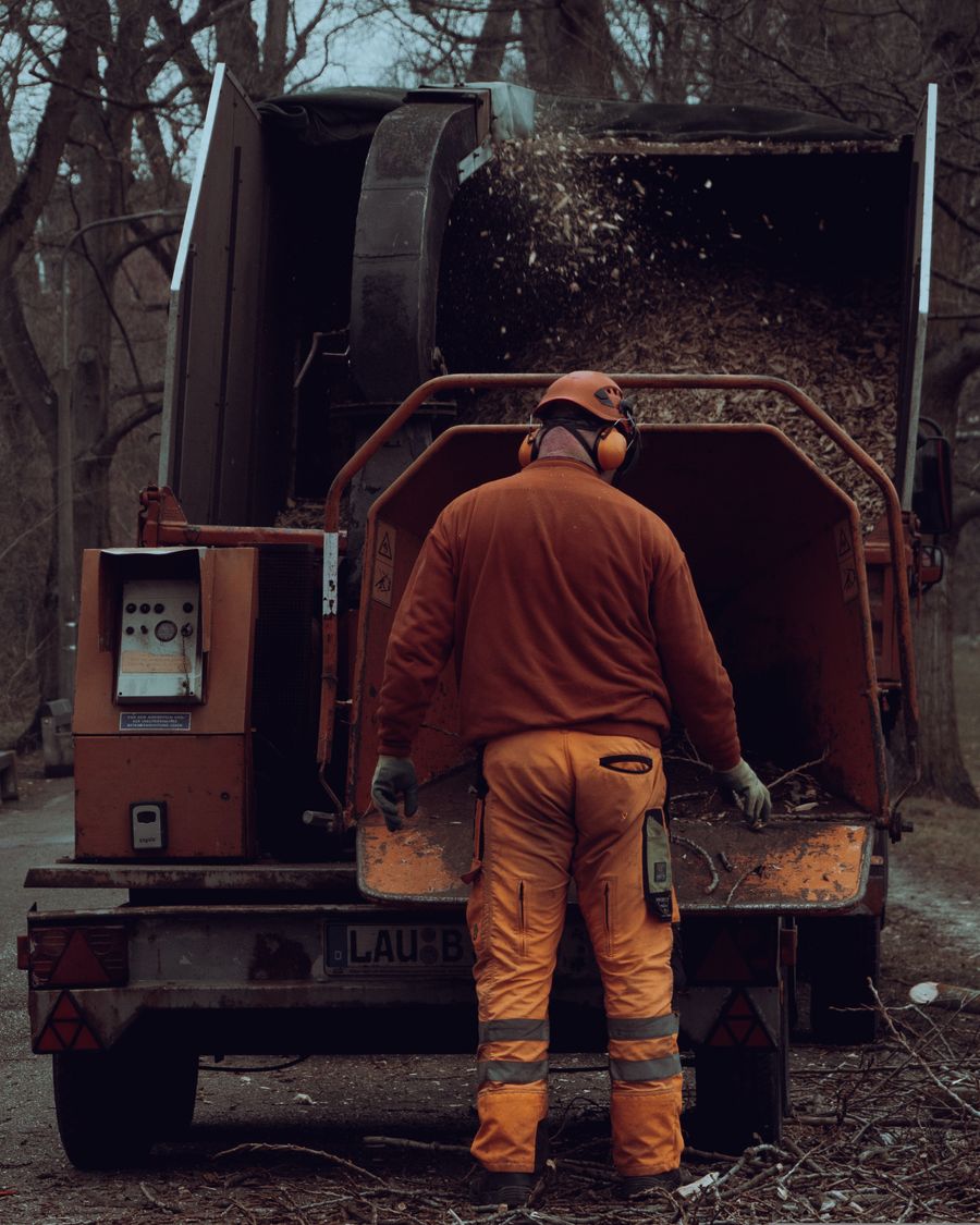 Crew member feeding brush into the chipper